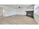 Spacious living room features a stone fireplace, ceiling fan, and wood-look flooring at 921 Sulphur Springs Ln # 201, Las Vegas, NV 89128