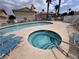 Community pool and hot tub with lounge chairs and palm trees at 921 Sulphur Springs Ln # 201, Las Vegas, NV 89128