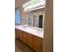 Bathroom featuring double sinks, generous counter space, and natural light at 9324 Pitching Wedge Dr, Las Vegas, NV 89134