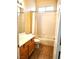 Well-lit bathroom features a wooden vanity with sink, toilet, bathtub and shower combination at 9324 Pitching Wedge Dr, Las Vegas, NV 89134