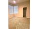 Bedroom with two large windows with blinds and plush carpeted floors at 9324 Pitching Wedge Dr, Las Vegas, NV 89134