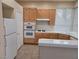 Full kitchen view features bright cabinets, white appliances, ample counter space, and natural light from a window at 9324 Pitching Wedge Dr, Las Vegas, NV 89134