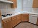 Bright kitchen featuring light wood cabinets, white appliances, and a tile countertop with a built-in cooktop at 9324 Pitching Wedge Dr, Las Vegas, NV 89134
