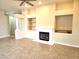 Living room area with fireplace, tile flooring, and neutral wall paint, and a ceiling fan at 9324 Pitching Wedge Dr, Las Vegas, NV 89134