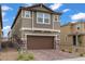 Well-maintained two-story home with attached garage, complemented by a brick driveway, and low maintenance front yard at 2742 Zazzera Ct, Henderson, NV 89044