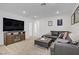Upstairs living room with entertainment center, leather sectional, and contemporary decor at 2742 Zazzera Ct, Henderson, NV 89044