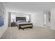 Spacious primary bedroom with king-size bed, ensuite bath, and neutral carpet at 2742 Zazzera Ct, Henderson, NV 89044