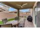 Inviting covered patio with outdoor seating and a grill, perfect for relaxing and entertaining in style at 2742 Zazzera Ct, Henderson, NV 89044