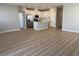 Open-concept living room showcasing modern flooring and a seamless transition to the kitchen with stainless appliances at 3224 Walker River St, North Las Vegas, NV 89032