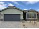 Charming single-story home featuring a two-car garage and desert landscaping at 3236 Walker River St, North Las Vegas, NV 89032