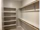 Walk-in closet featuring shelving and wooden rails for organized storage at 3236 Walker River St, North Las Vegas, NV 89032