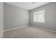 Clean bedroom with neutral walls, carpet, and a window for natural light at 3240 Walker River St, North Las Vegas, NV 89032