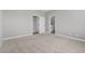 Spacious carpeted bedroom with neutral walls and two entryways, one leading to the bathroom at 3240 Walker River St, North Las Vegas, NV 89032