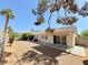 Gravel backyard showcasing a covered patio with exterior access via sliding glass doors at 3523 Calf Roper Ct, North Las Vegas, NV 89032