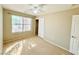 Sunlit bedroom with a closet, ceiling fan, and a large window offering neighborhood views at 3523 Calf Roper Ct, North Las Vegas, NV 89032
