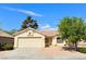 Single-story home with a two-car garage and well-maintained landscaping at 3523 Calf Roper Ct, North Las Vegas, NV 89032