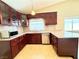 Cozy kitchen features cherry cabinets, an undermount sink, granite counters, and stainless appliances at 3523 Calf Roper Ct, North Las Vegas, NV 89032