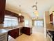 Kitchen featuring cherry wood cabinetry, granite countertops and stainless steel appliances at 3523 Calf Roper Ct, North Las Vegas, NV 89032