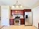 Kitchen features granite counters, cherry cabinets, stainless steel appliances, and updated fixtures at 3523 Calf Roper Ct, North Las Vegas, NV 89032