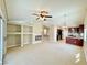 Open-concept living room view of fireplace, built-in shelves, and the adjacent kitchen area at 3523 Calf Roper Ct, North Las Vegas, NV 89032