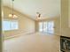 Spacious living room with sliding glass doors leading to the patio, fireplace, and ceiling fan at 3523 Calf Roper Ct, North Las Vegas, NV 89032