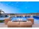 Luxury pool area with stunning desert and lake views, an outdoor kitchen, and modern fire pit lounge at 36 Thorn Creek St, Henderson, NV 89011