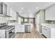 Open kitchen showcasing stainless appliances, and view to the living area at 5332 Hadley Ct, North Las Vegas, NV 89031