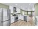 Open concept kitchen with stainless steel appliances and view into adjacent living space at 5332 Hadley Ct, North Las Vegas, NV 89031