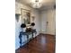 Elegant entryway with hardwood floors, decorative console table, chandelier and stylish decor at 682 Oakmont Ave # 1507, Las Vegas, NV 89109