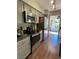 Updated kitchen with stainless steel appliances, granite countertops, grey cabinets, and hardwood floors at 682 Oakmont Ave # 1507, Las Vegas, NV 89109