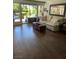 Bright living room with hardwood floors, comfortable sofa and seamless access to the outdoor patio at 682 Oakmont Ave # 1507, Las Vegas, NV 89109