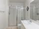 Bright bathroom with dual sinks, white tile countertops, and glass-enclosed shower at 8452 Boseck Dr # 225, Las Vegas, NV 89145