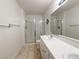 Bright bathroom with dual sinks, white tile countertops, and glass-enclosed shower at 8452 Boseck Dr # 225, Las Vegas, NV 89145