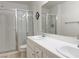 Bright bathroom with dual sinks, white tile countertops, and glass-enclosed shower at 8452 Boseck Dr # 225, Las Vegas, NV 89145