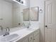Well-lit bathroom featuring double sinks and a large mirror at 8452 Boseck Dr # 225, Las Vegas, NV 89145