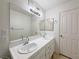Bright bathroom featuring double sinks and a large mirror at 8452 Boseck Dr # 225, Las Vegas, NV 89145