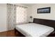 Bedroom featuring wood floors, a large window, and minimalist decor at 8452 Boseck Dr # 225, Las Vegas, NV 89145