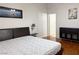 Bedroom featuring wood floors, a large window, and minimalist decor at 8452 Boseck Dr # 225, Las Vegas, NV 89145