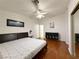 Bedroom featuring wood floors, a large window, and minimalist decor at 8452 Boseck Dr # 225, Las Vegas, NV 89145