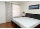 Bedroom featuring wood floors, a large window, and minimalist decor at 8452 Boseck Dr # 225, Las Vegas, NV 89145