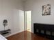 Bedroom featuring wood floors, a large window, and minimalist decor at 8452 Boseck Dr # 225, Las Vegas, NV 89145