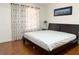 Bedroom featuring wood floors, a large window, and minimalist decor at 8452 Boseck Dr # 225, Las Vegas, NV 89145
