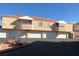 Inviting multi-Gathering home featuring a well-maintained stucco exterior and ample garage parking spaces at 8452 Boseck Dr # 225, Las Vegas, NV 89145