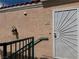 Exterior of home featuring security door, stairs and sconce lighting at 8452 Boseck Dr # 225, Las Vegas, NV 89145