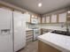 Bright kitchen features tile countertops, white appliances, and wooden cabinets at 8452 Boseck Dr # 225, Las Vegas, NV 89145