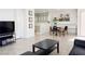 Open living room with tile flooring flows into the dining area and features a well-lit, airy atmosphere at 8452 Boseck Dr # 225, Las Vegas, NV 89145