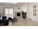 Bright living room features a fireplace, tile floors, and sliding door to the outside at 8452 Boseck Dr # 225, Las Vegas, NV 89145