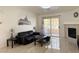 A cozy living room with tile floors, a sliding glass door to the balcony, and a modern fireplace at 8452 Boseck Dr # 225, Las Vegas, NV 89145