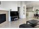 Bright living room with tile floors, a fireplace, and an open view to the kitchen and dining area at 8452 Boseck Dr # 225, Las Vegas, NV 89145