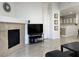 Bright living room featuring tile floors, a fireplace, and an open floor plan into the kitchen at 8452 Boseck Dr # 225, Las Vegas, NV 89145